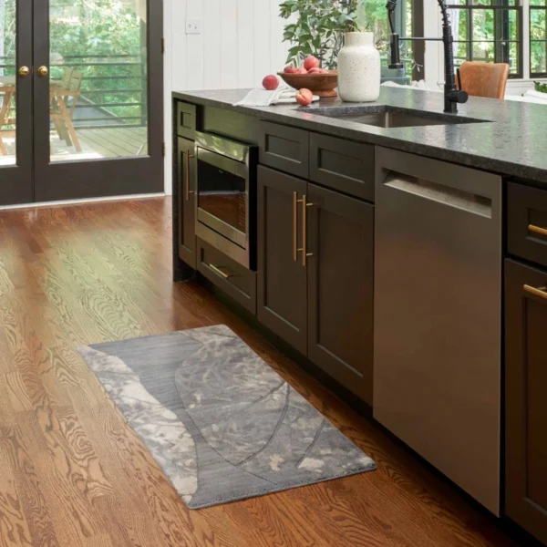 A kitchen with a sink and wooden floors